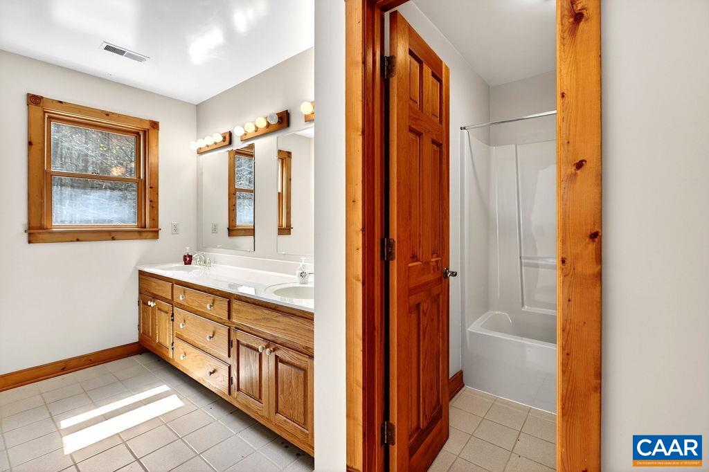 472 Horseshoe Mountain Road Roseland, VA 22967 - Photo 58 of 75 a bathroom with a double vanity sink and a mirror