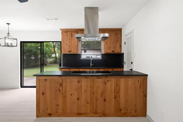a view of an empty room with glass door and garden
