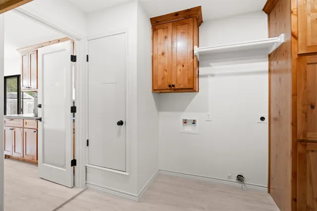 an empty room with closet and windows