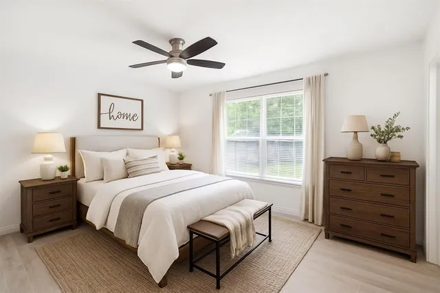 a bedroom with a bed and a window