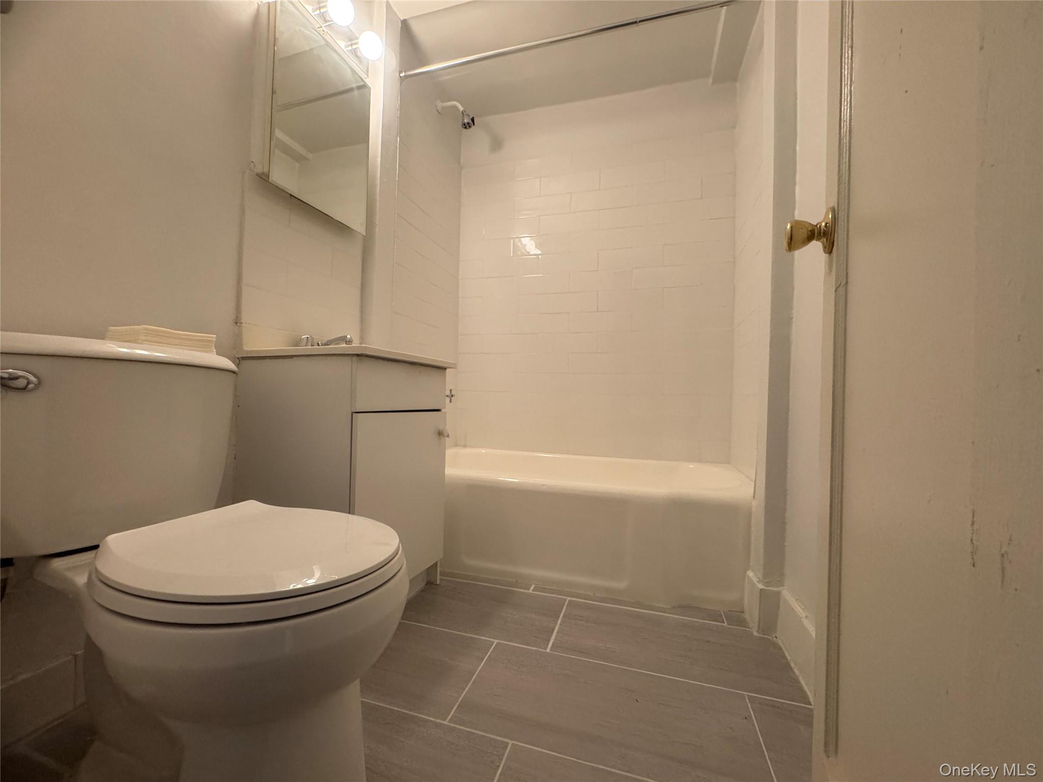 99-21 67th Road, Unit 7K Queens, NY 11375 - Photo 9 of 10 a bathroom with a toilet and a shower