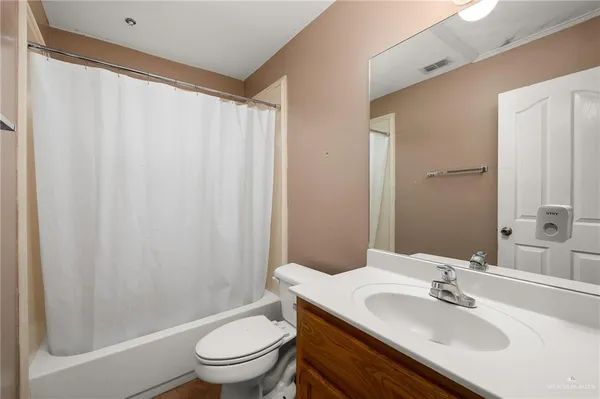 a bathroom with a sink toilet and a mirror
