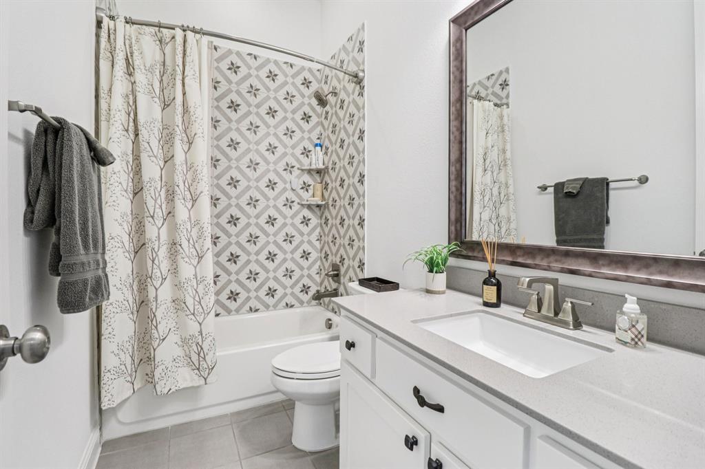 8277 Halifax The Colony, TX 75056 - Photo 24 of 37 a bathroom with a granite countertop sink toilet and shower
