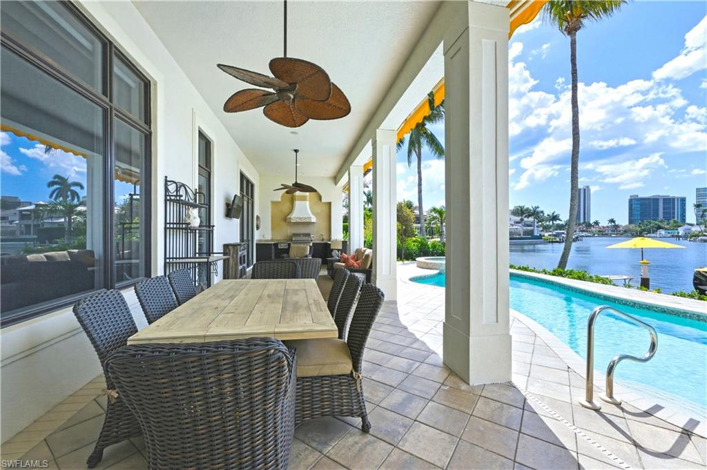361 Pirates Bight Naples, FL 34103 - Photo 37 of 45 a dining room with furniture and a floor to ceiling window