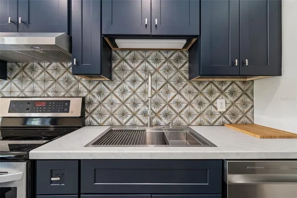 a kitchen with a sink and a stove top oven