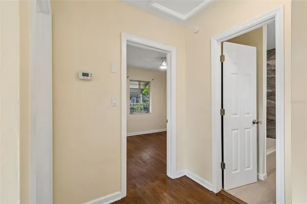 a view of a hallway with wooden floor