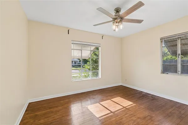wooden floor in an empty room with a window