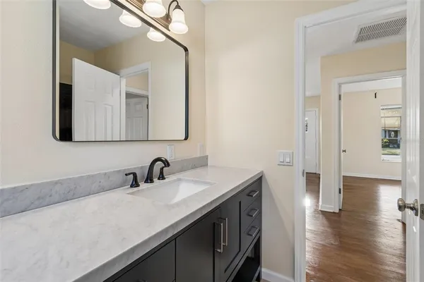 a en suite bathroom with a double vanity sink and a mirror