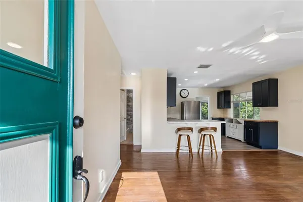 a view of a a dining room with furniture window and wooden floor