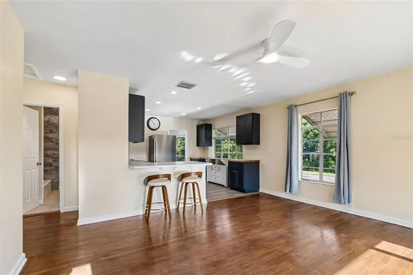 a view of a kitchen with furniture window and wooden floor