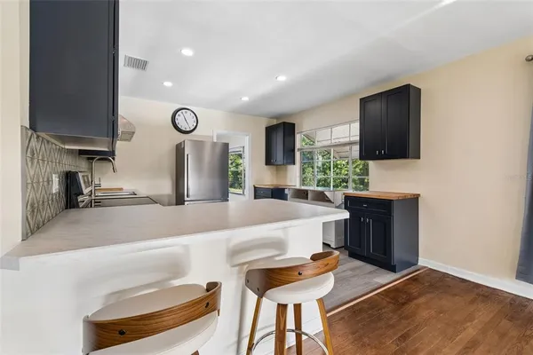 a large kitchen with a table and chairs in it
