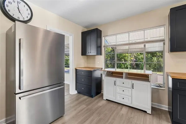 a kitchen with a refrigerator and a sink