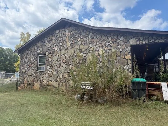 a view of a field of grass and trees
