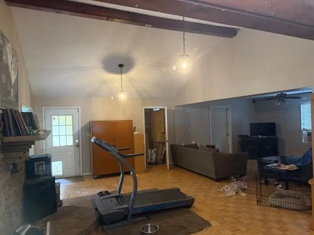 a living room with furniture gym equipment and a chandelier