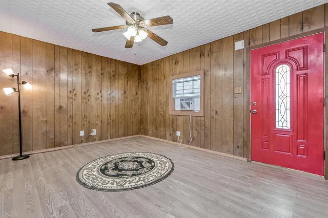 a view of a livingroom with a workspace window and wooden floor
