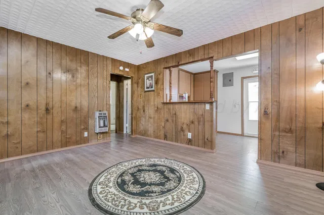 wooden floor in an empty room with a bathroom
