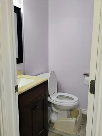 an empty room with wooden floor and entrance