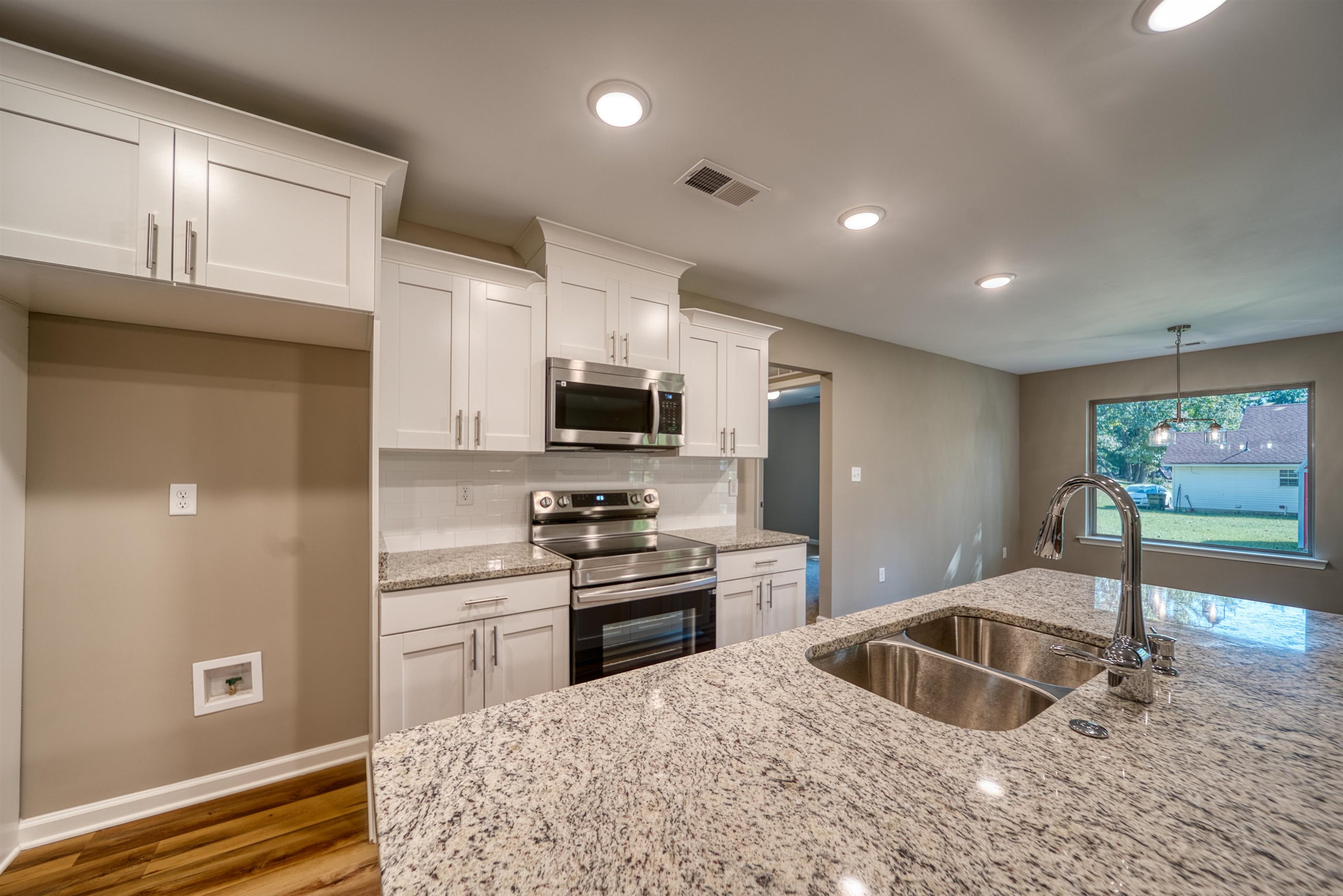 109 Walnut Ridge Ripley, TN 38063 - Photo 12 of 39 a kitchen with stainless steel appliances granite countertop a sink and a stove