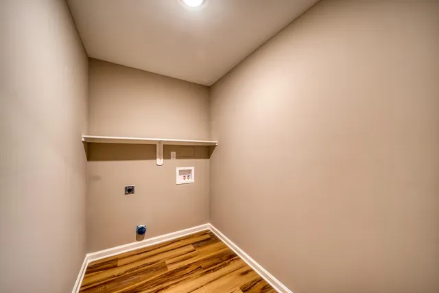 a view of a livingroom with wooden floor and closet