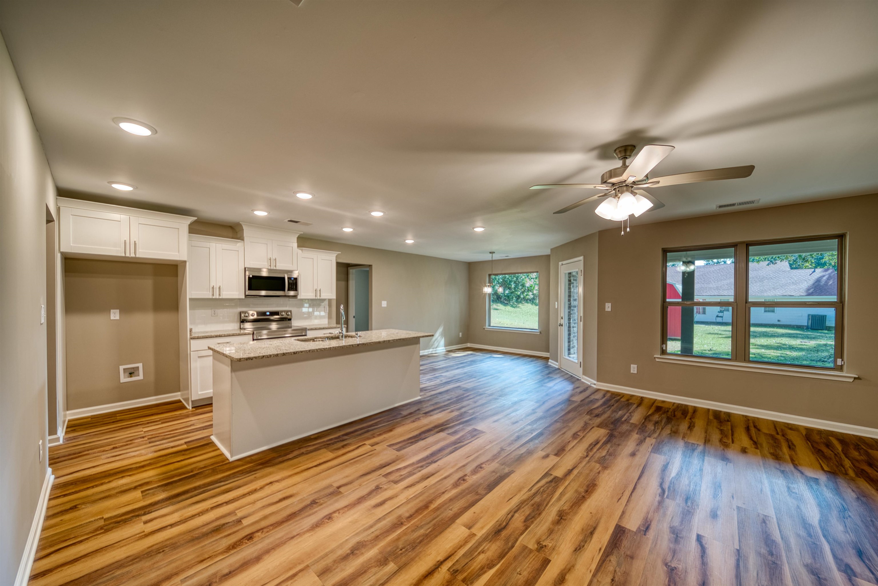 109 Walnut Ridge Ripley, TN 38063 - Photo 37 of 39 Kitchen featuring recessed lighting, open floor plan, white cabinets, an island with sink, and stainless steel appliances
