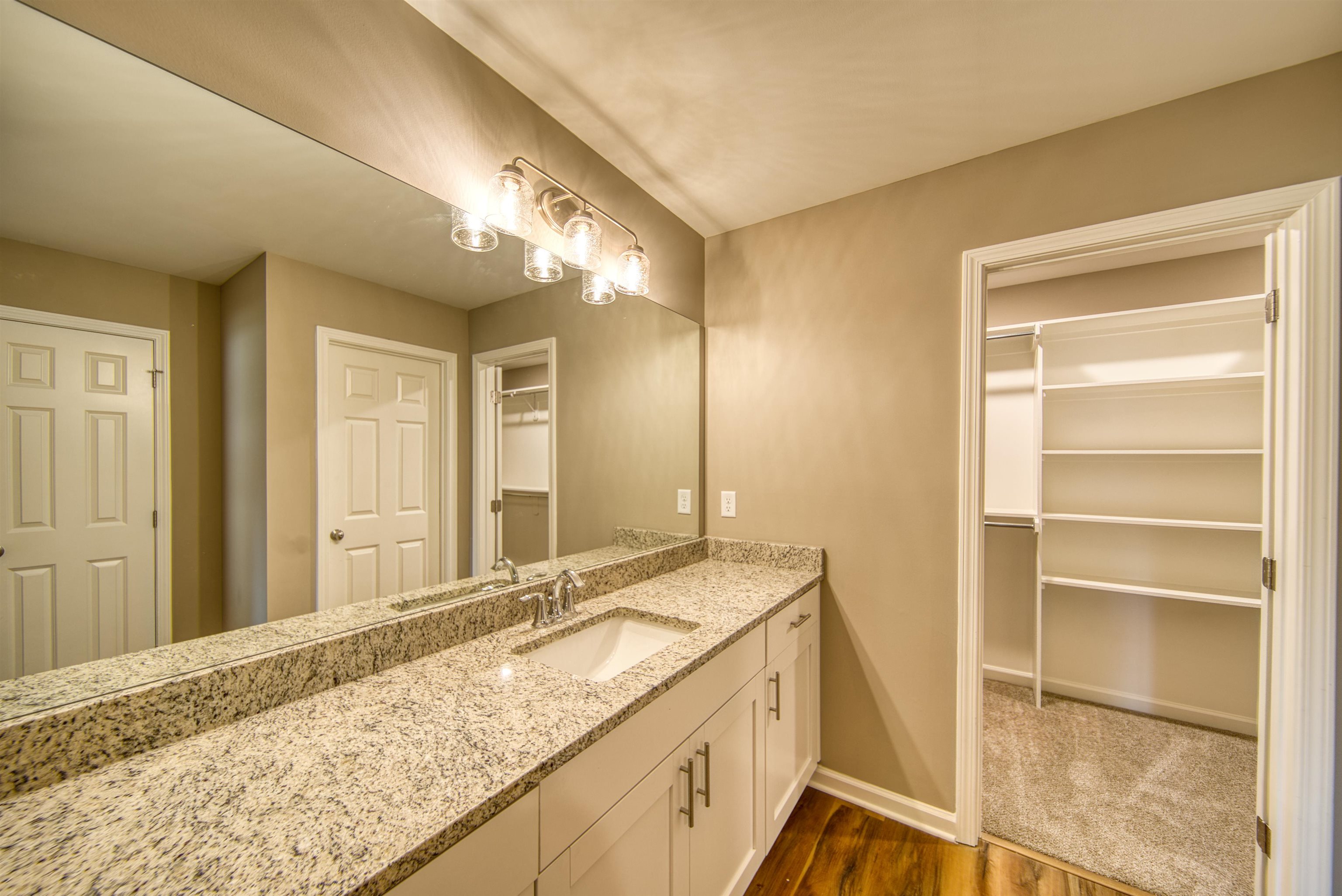 109 Walnut Ridge Ripley, TN 38063 - Photo 20 of 39 a bathroom with a granite countertop sink and a mirror