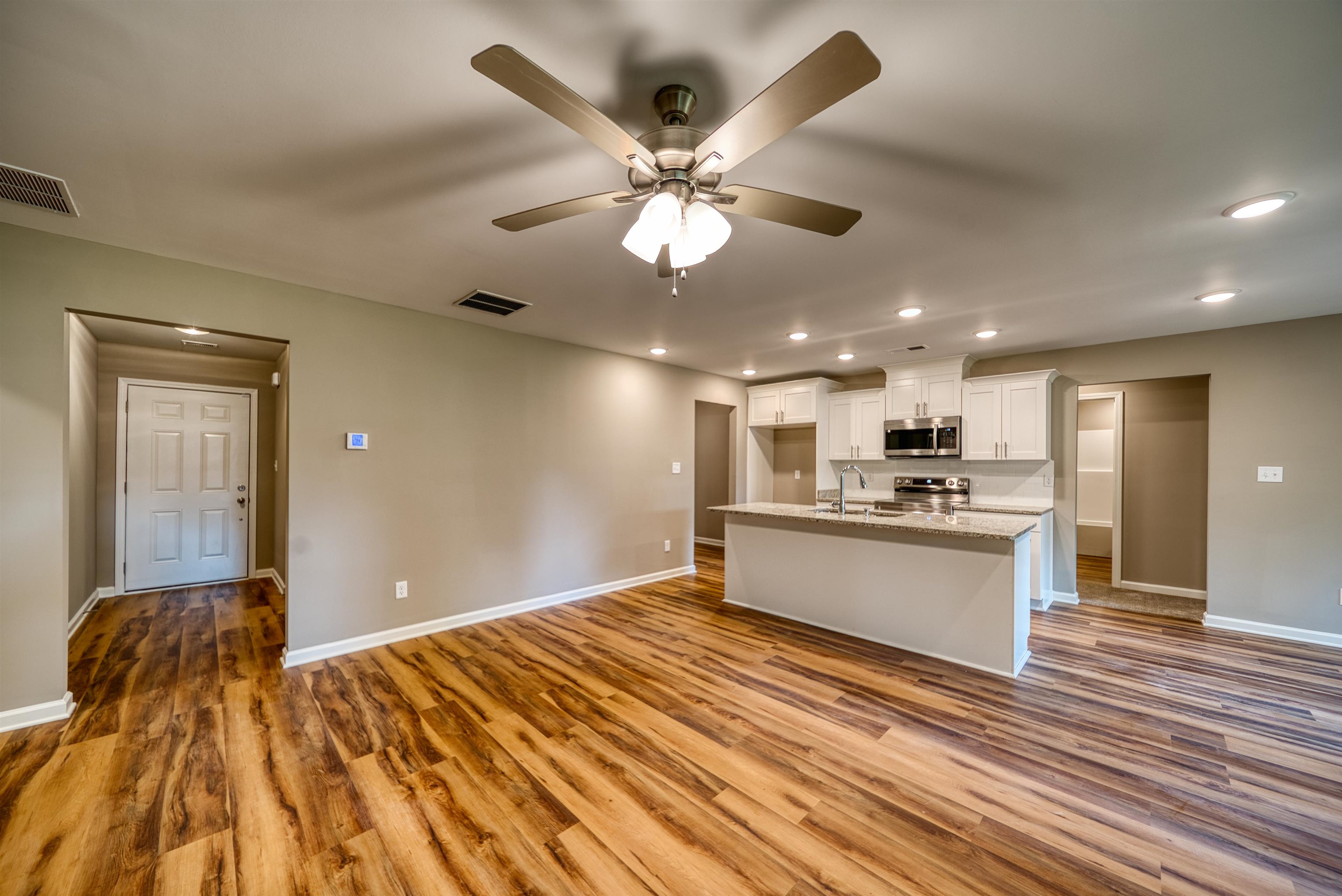 109 Walnut Ridge Ripley, TN 38063 - Photo 38 of 39 Kitchen featuring open floor plan, recessed lighting, white cabinets, light wood-style flooring, and stainless steel appliances