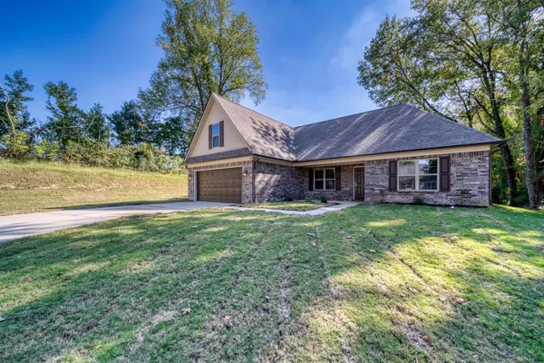 a kitchen with stainless steel appliances granite countertop a sink dishwasher and a stove with wooden floor