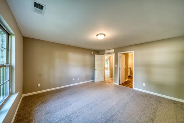 an empty room with a empty space and windows