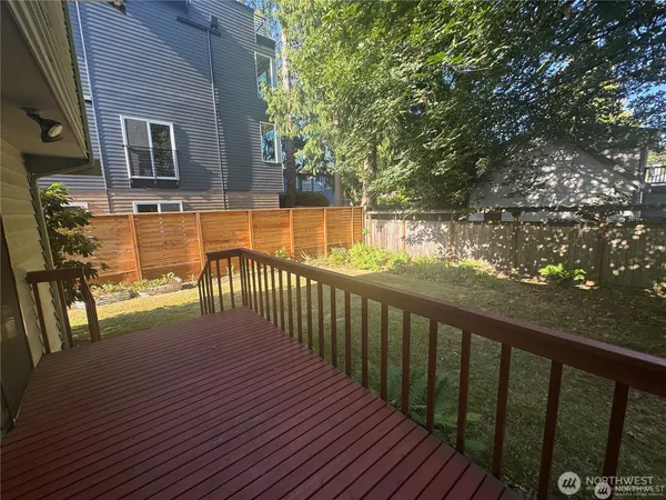 a balcony with wooden floor and outdoor seating