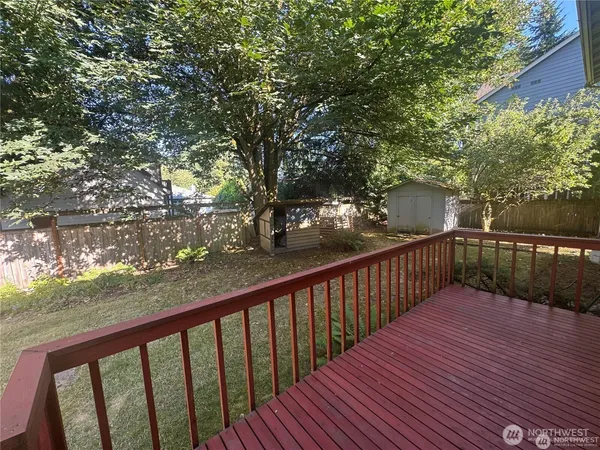 a balcony with wooden floor and trees