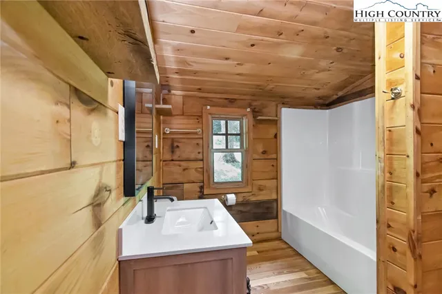 a bathroom with a sink a bathtub and shower