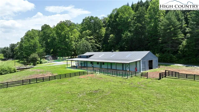 a view of a house with a yard deck and a slide