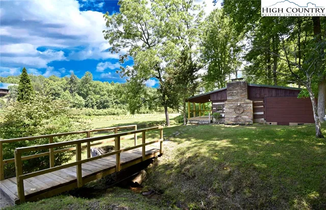 a view of a wooden deck and a yard