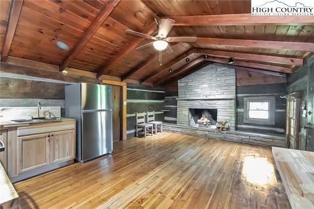 a view of a kitchen with a sink and a refrigerator