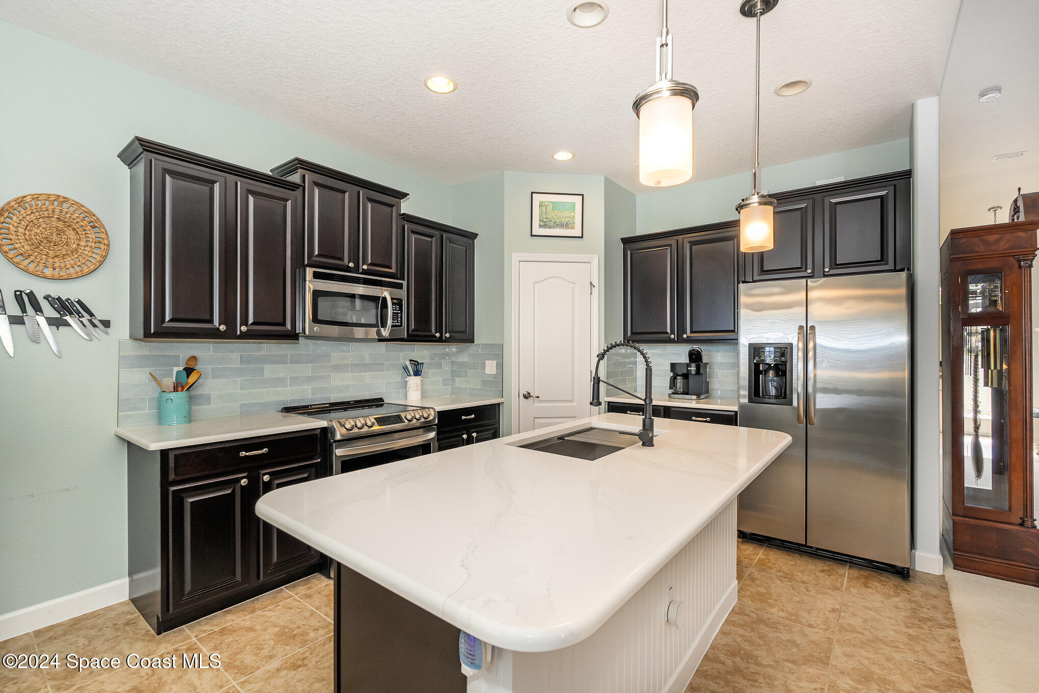 3354 Sansome Circle Melbourne, FL 32940 - Photo 13 of 81 a kitchen with stainless steel appliances granite countertop a sink a stove and refrigerator