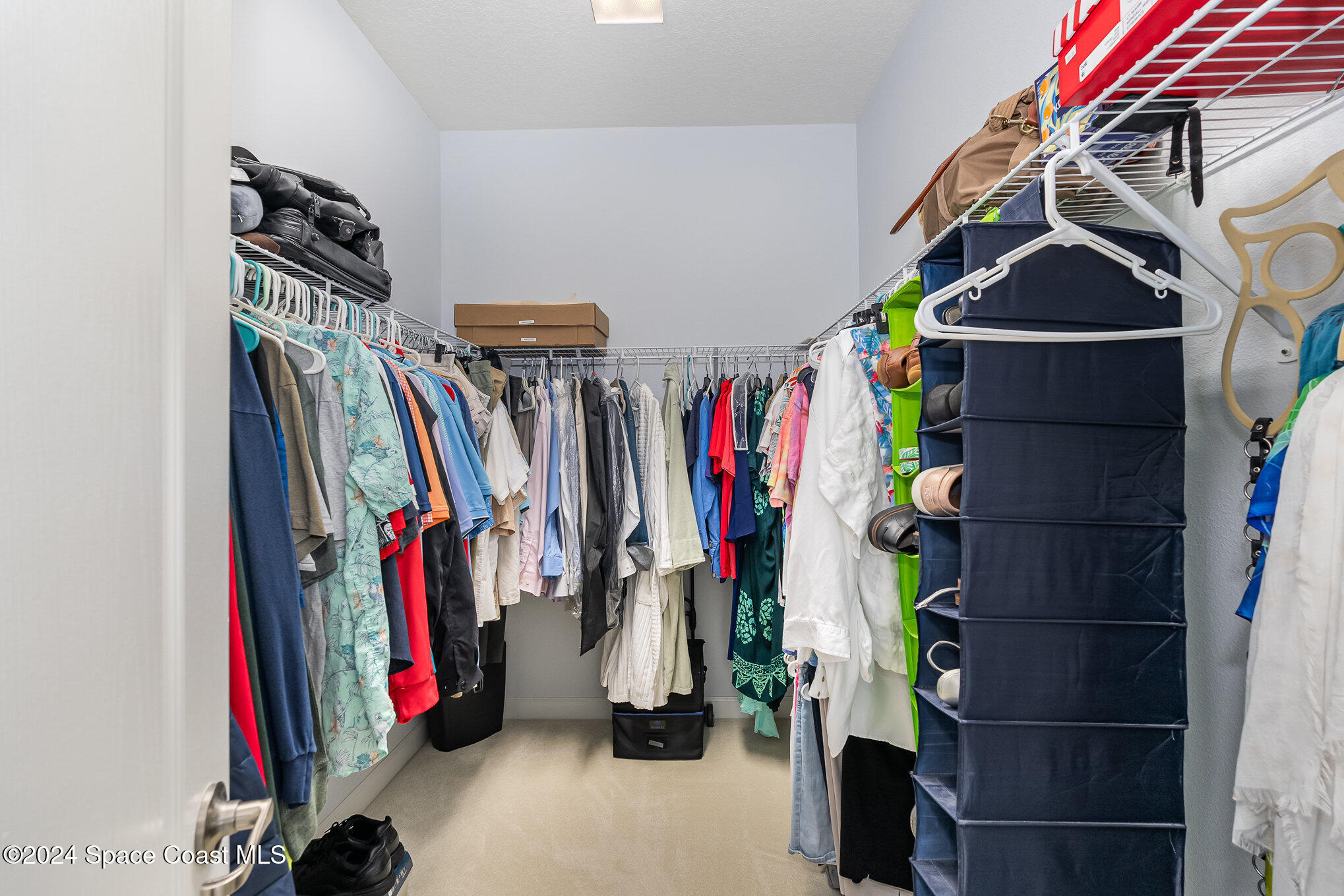 3354 Sansome Circle Melbourne, FL 32940 - Photo 17 of 81 a view of walk in closet with clothes and shoes