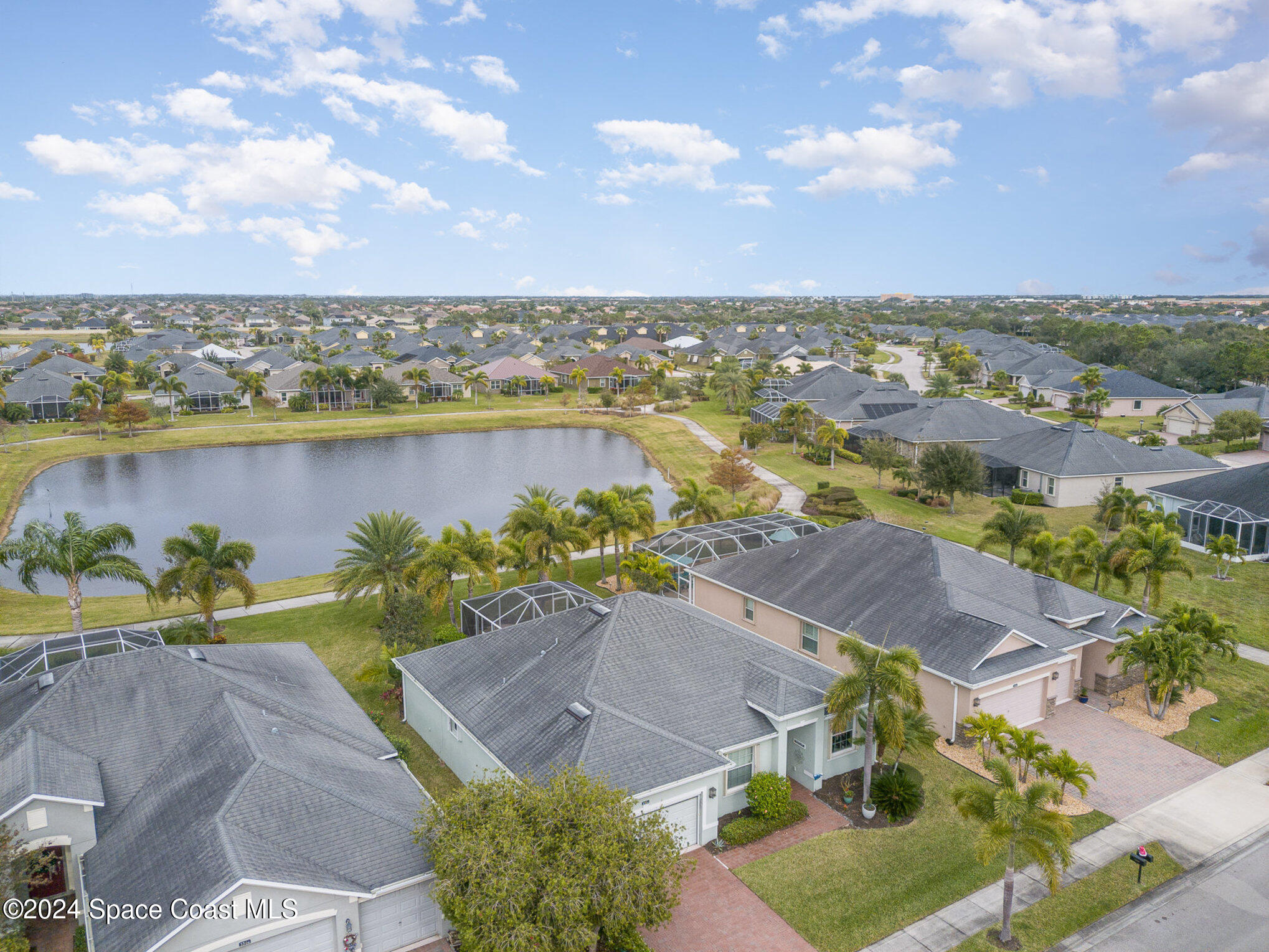 3354 Sansome Circle Melbourne, FL 32940 - Photo 2 of 81 an aerial view of a house with a lake view
