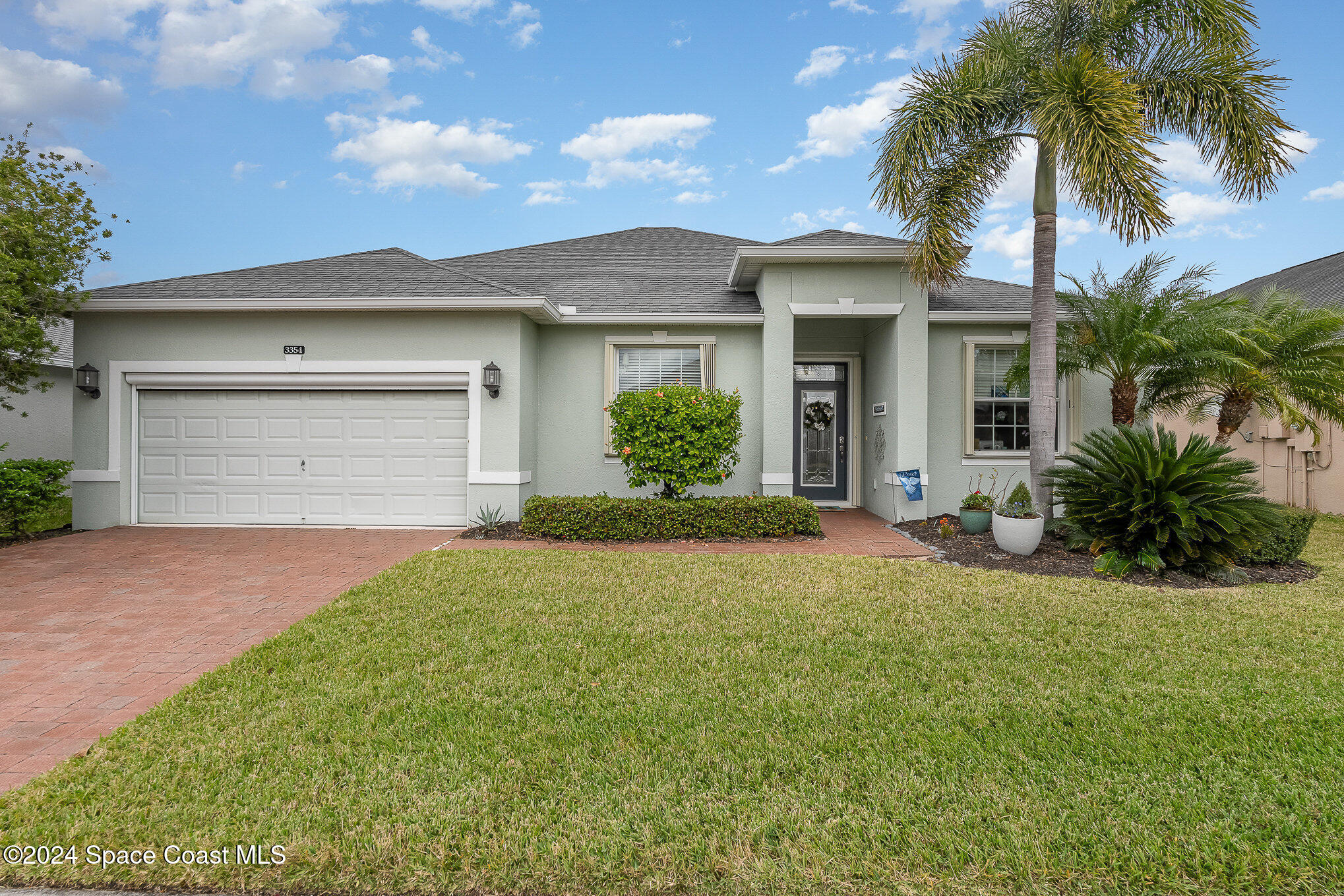 3354 Sansome Circle Melbourne, FL 32940 - Photo 3 of 81 a front view of a house with a garden and yard