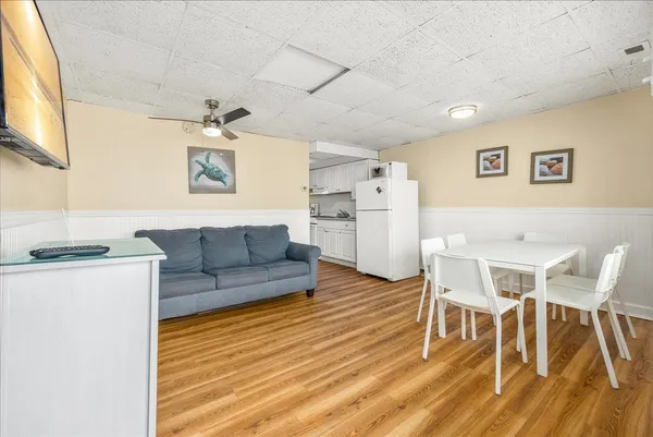 a kitchen with stainless steel appliances granite countertop a sink a stove a refrigerator and white cabinets
