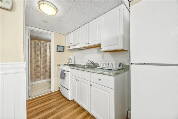a bedroom with a large bed and a ceiling fan