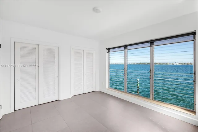 a kitchen with granite countertop a sink stove and refrigerator