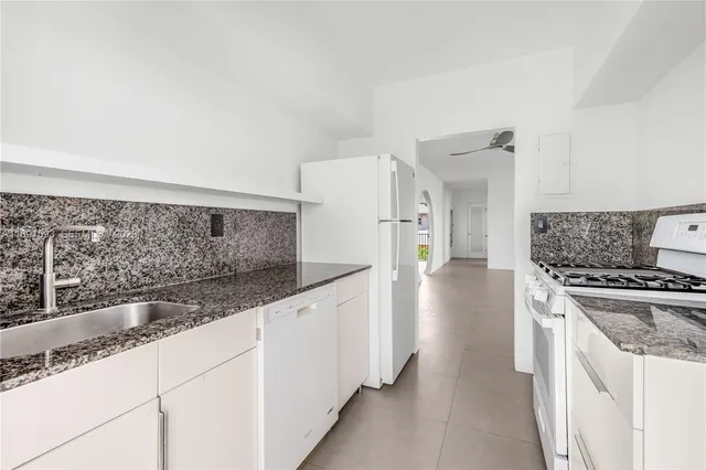 a view of a kitchen with a sink and outdoor seating