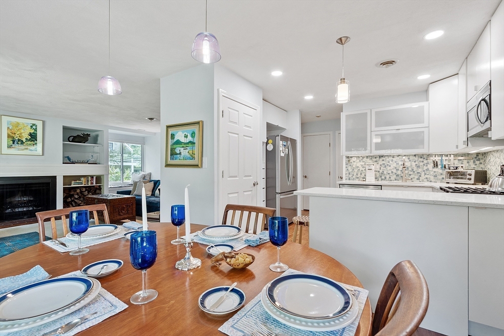 1 Concord Greene, Unit 7 Concord, MA 01742 - Photo 15 of 31 a kitchen with a table chairs stove and kitchen view