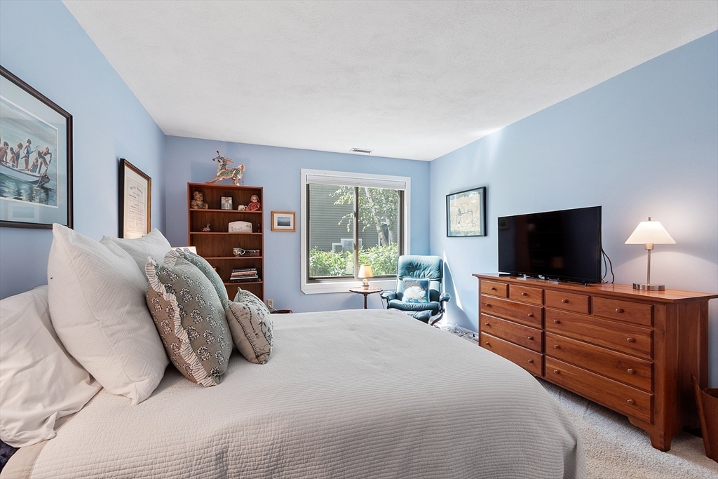 1 Concord Greene, Unit 7 Concord, MA 01742 - Photo 20 of 31 a bedroom with a bed and a flat screen tv