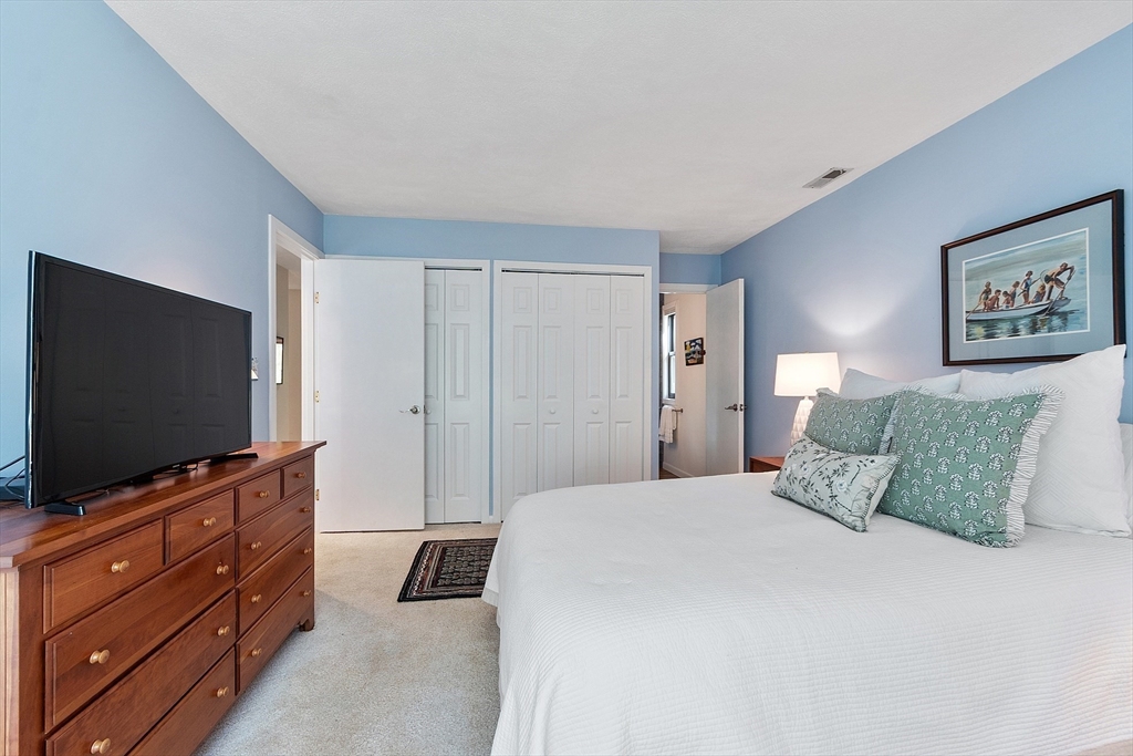 1 Concord Greene, Unit 7 Concord, MA 01742 - Photo 21 of 31 a bedroom with a large bed and a flat screen tv