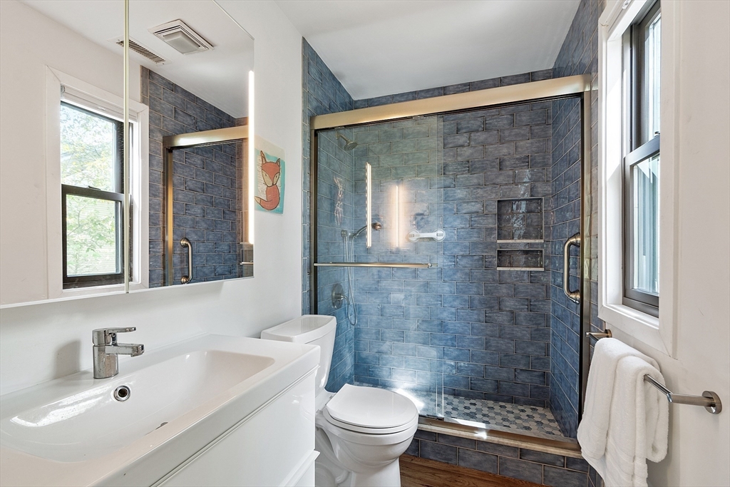 1 Concord Greene, Unit 7 Concord, MA 01742 - Photo 22 of 31 a bathroom with a sink a toilet and shower