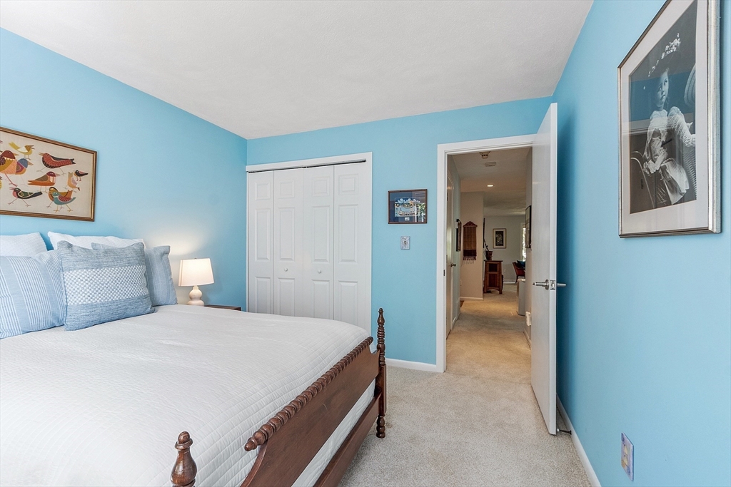 1 Concord Greene, Unit 7 Concord, MA 01742 - Photo 23 of 31 a bedroom with a bed and wall painting