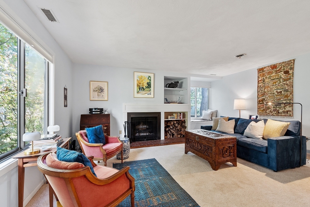 1 Concord Greene, Unit 7 Concord, MA 01742 - Photo 4 of 31 a living room with furniture fireplace and a large window