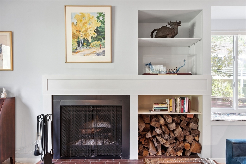 1 Concord Greene, Unit 7 Concord, MA 01742 - Photo 5 of 31 a living room with a fireplace and a window