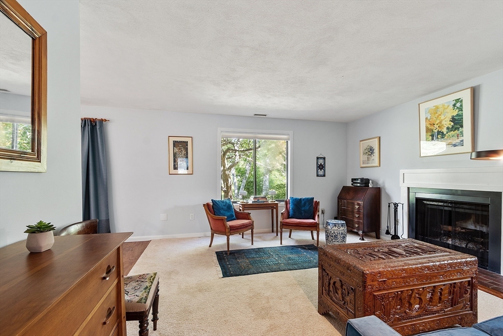 1 Concord Greene, Unit 7 Concord, MA 01742 - Photo 6 of 31 a living room with furniture and a fireplace